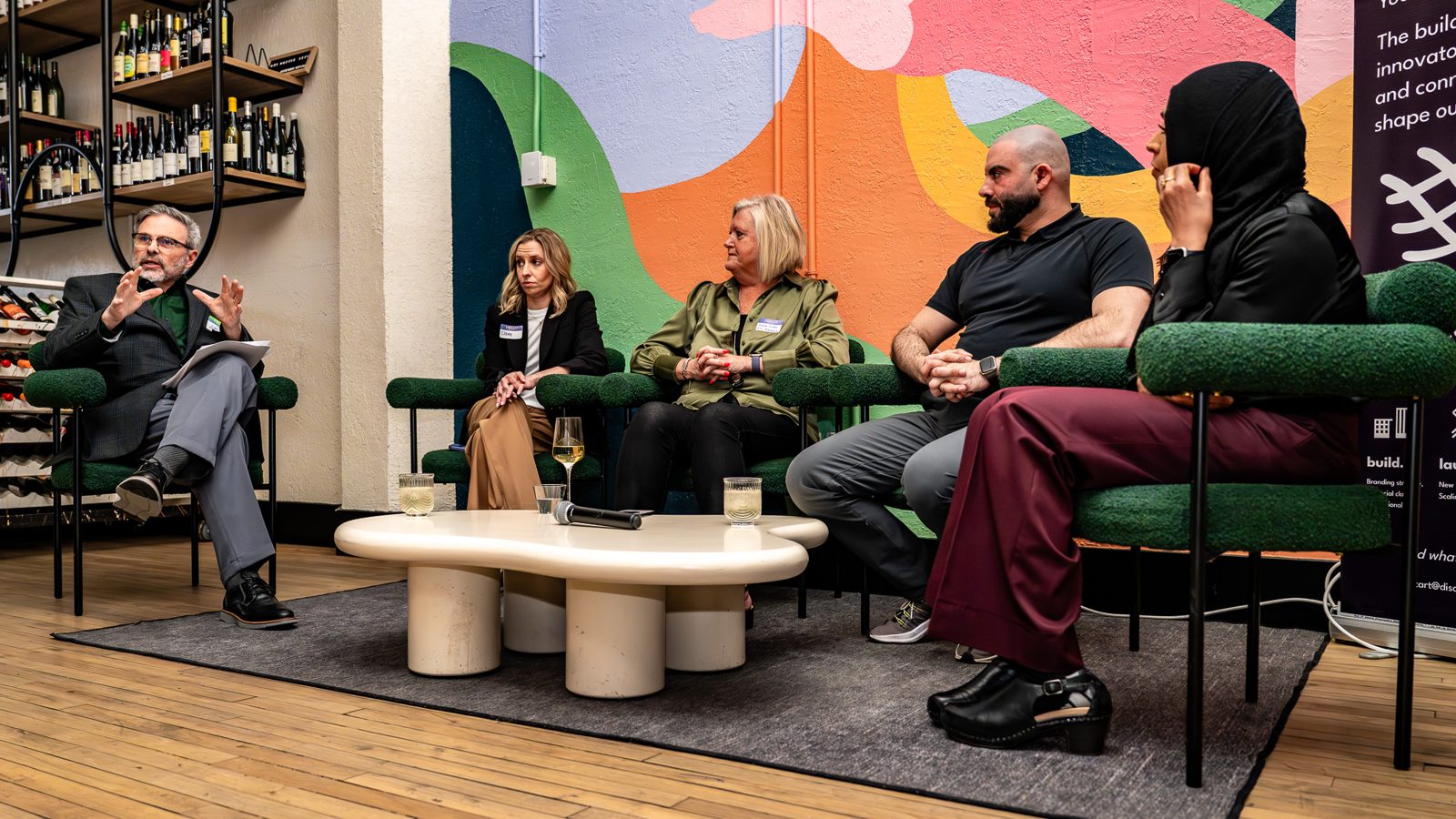 Founders speaking on a panel to a seated audience